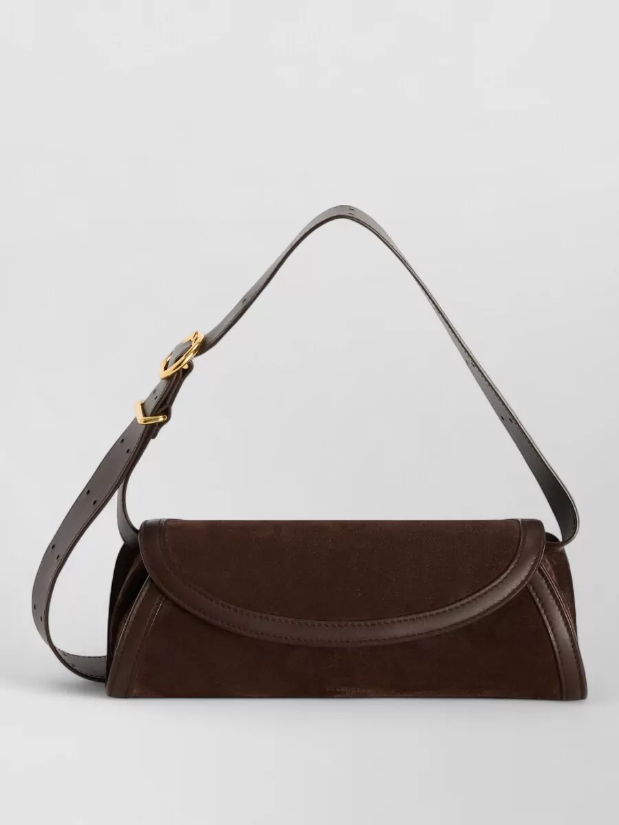 Jil Sander cannolo small leather shoulder bag — The Jil Sander dark chocolate suede baguette keeps the palette deep and tonal with the espresso boots and charcoal dress, adding structure and refinement without breaking the minimalist mood.