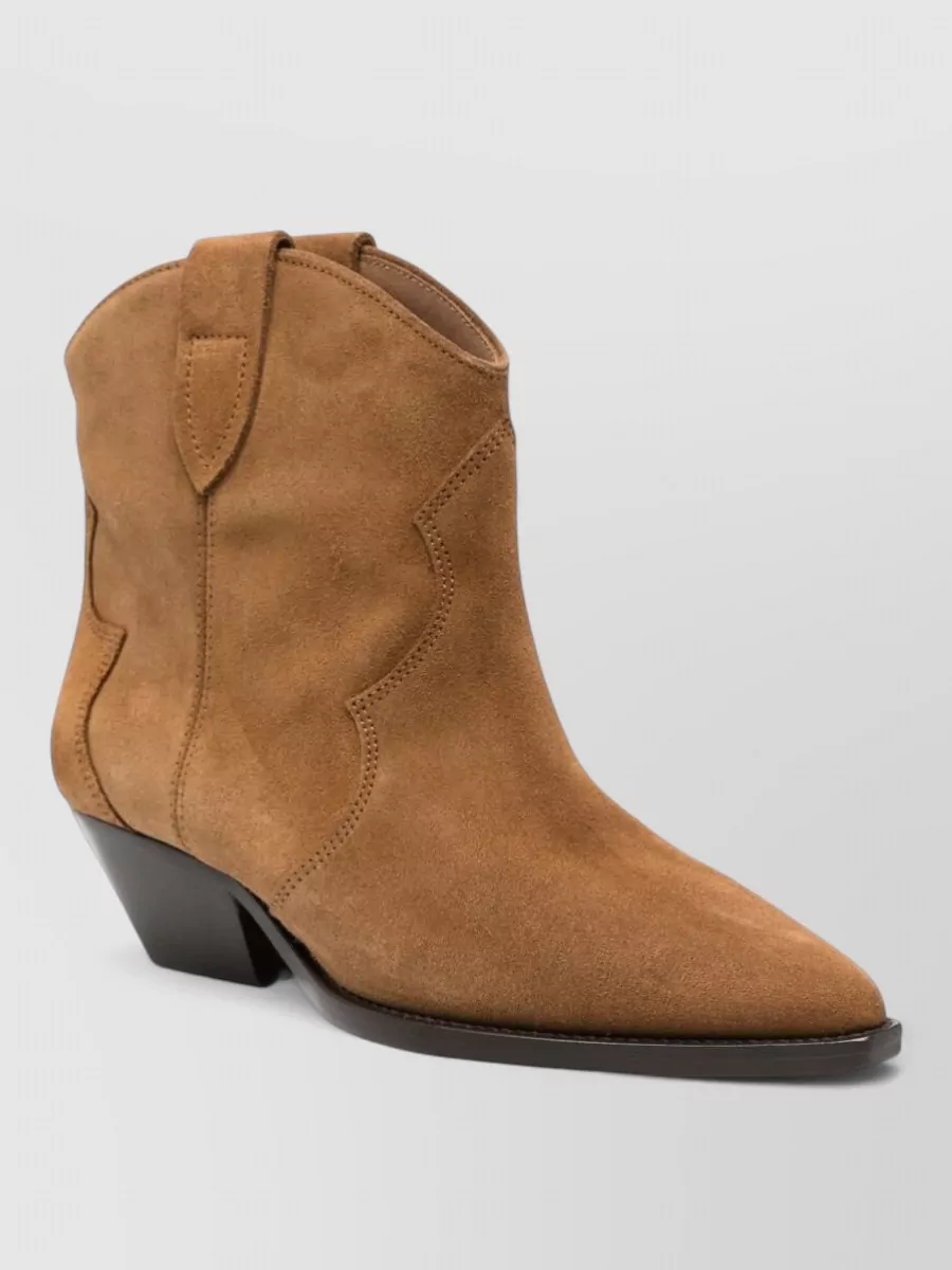 Isabel Marant Suede leather cowboy boots — The tan suede western ankle boots bring Isabel Marant’s signature Paris-meets-frontier energy, link tonally to the camel top, and sit cleanly over wide denim without feeling heavy.