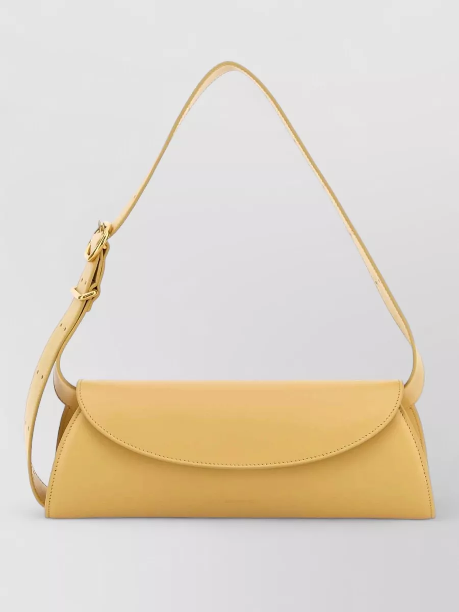 Jil Sander cannolo small leather shoulder bag — The Jacquemus ivory crochet tote reinforces the romantic, boho mood and adds airy texture that complements the skirt’s embroidery without introducing new strong colours.