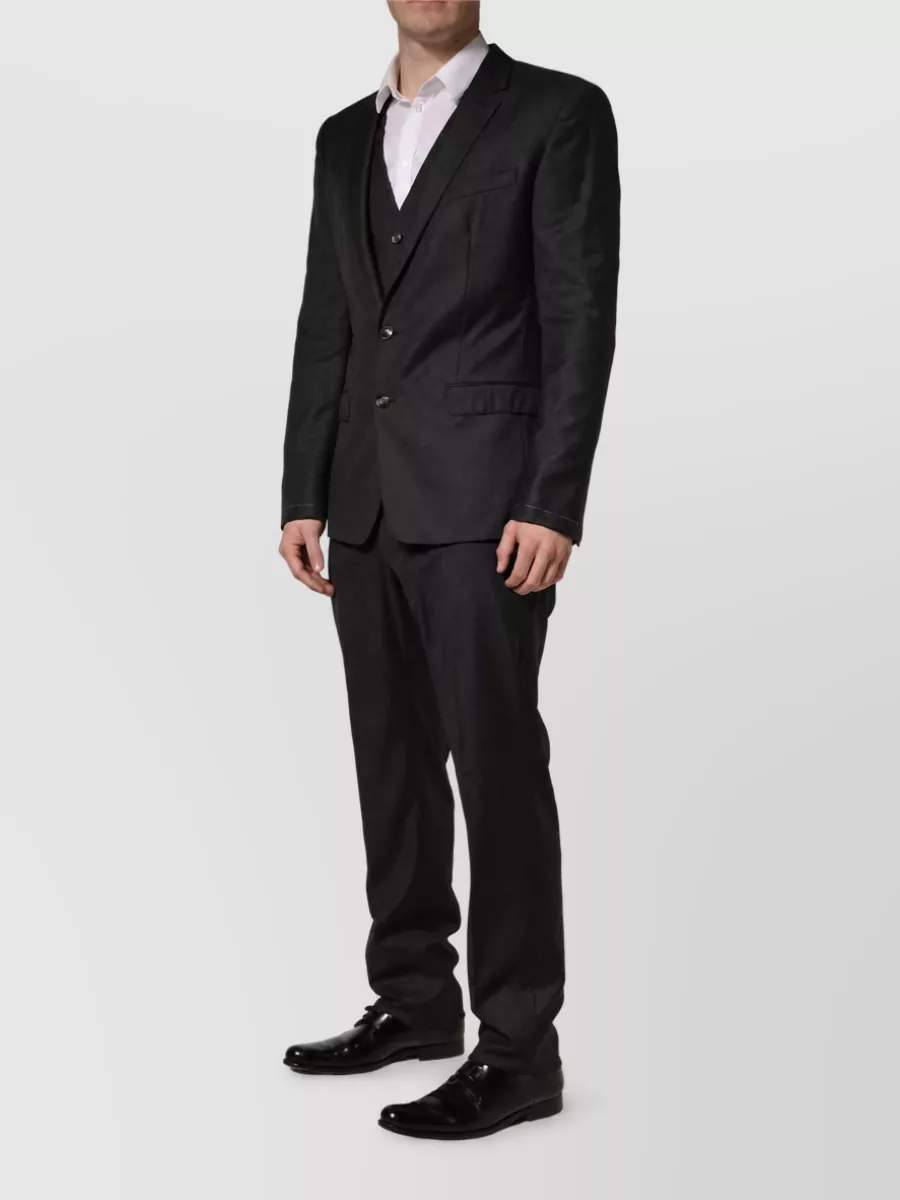 Dolce&Gabbana Virgin wool slim-fit single-breasted three-piece suit — The charcoal-black three-piece suit keeps the tailored, quiet-luxury evening mood of the source while adding a waistcoat for extra formality and structure.