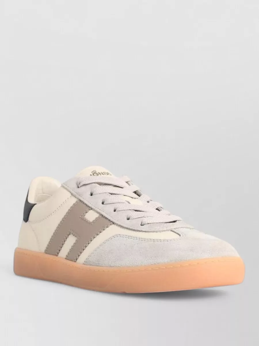 Hogan Leather low-top sneakers — The cream and taupe Hogan court sneakers echo the henley’s off-white, sit perfectly with dark denim, and maintain a refined but relaxed preppy feel for casual days.