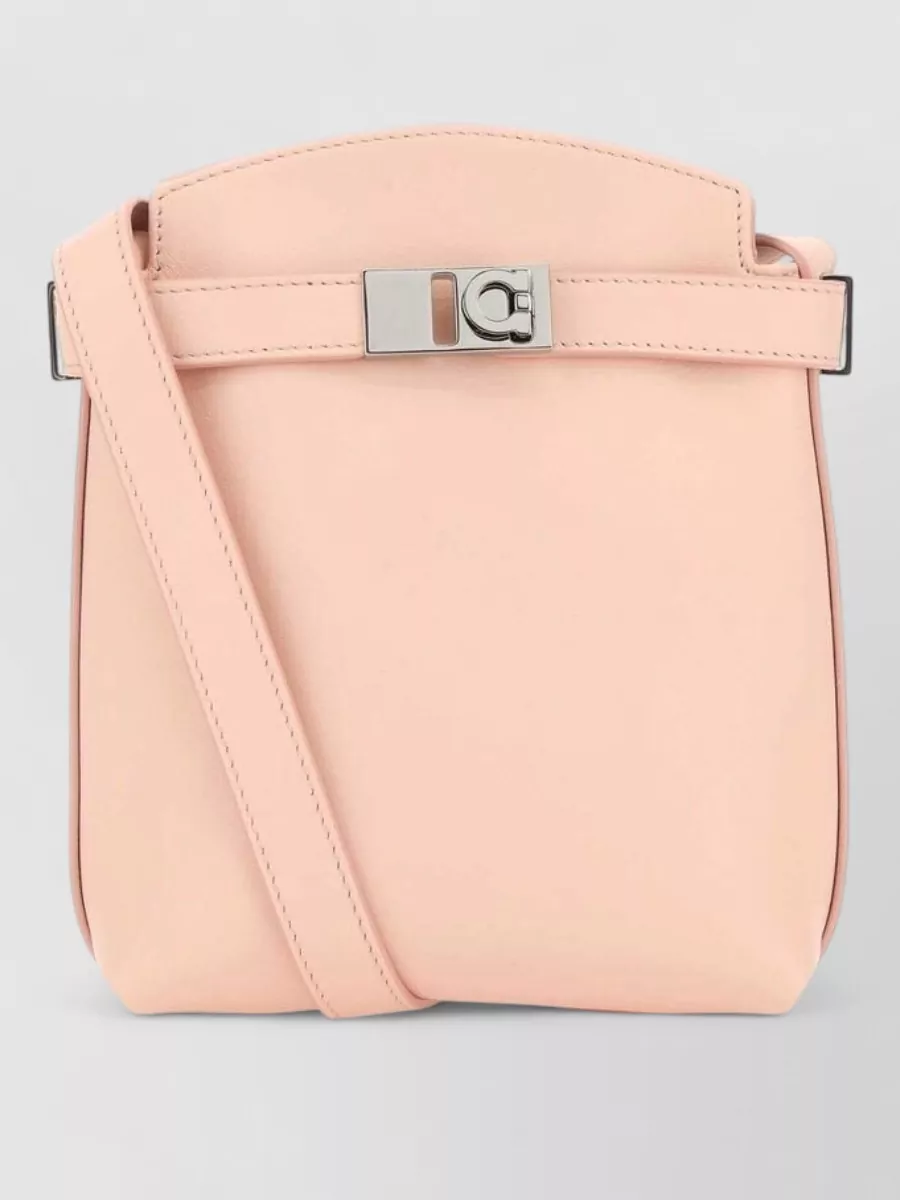 Ferragamo gancini leather cross-body bag — Ferragamo’s blush cross-body sits in the same quiet-luxury space and repeats the nude-rose tones, adding a compact structured finish without competing with the floral twilly.