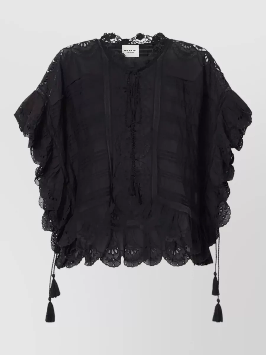 Isabel Marant Etoile Cotton floral-lace asymmetric blouse — The floaty black lace blouse mirrors the shorts’ broderie and ruffles for a cohesive romantic-boho set, while its loose volume balances the fitted mid-rise waist without breaking the all-black palette.