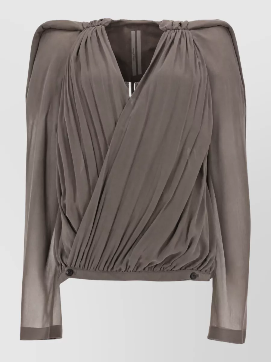 Rick Owens Silk blouse — The taupe-grey draped wrap blouse in H mirrors the pants’ softness while keeping the palette warm and tonal, creating a sensual but composed balance between sheer volume and quiet structure.