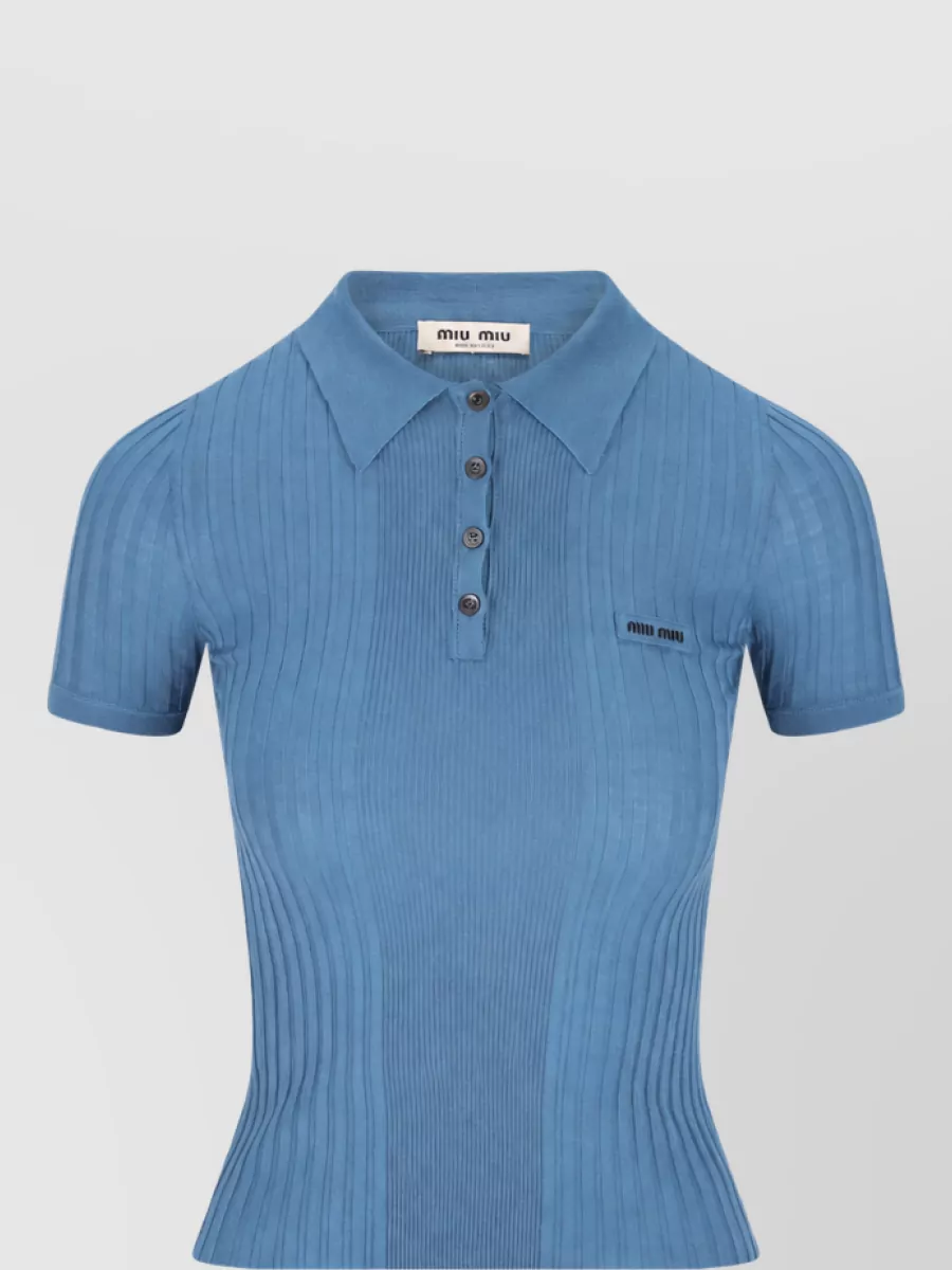 Miu Miu Ribbed wool short-sleeve polo top — The dusty blue slim ribbed polo tucks neatly into the full ivory skirt, echoing its preppy romance while keeping the silhouette clean and waist‑defining in a soft, complementary pastel tone.