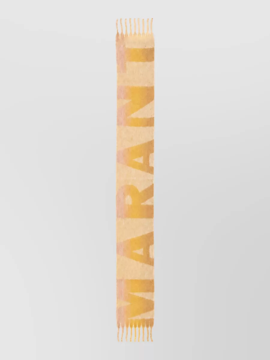 Isabel Marant Loliana scarf — The Isabel Marant buttercream and honey scarf can be loosely draped or tied to pick up the dress’s yellow tones and add a cozy, boho layer for cooler evenings.