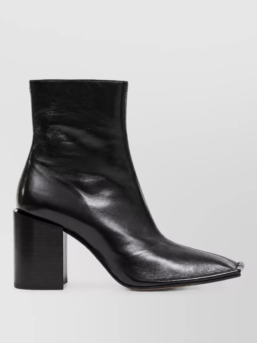 Maison Margiela Leather square-toe ankle boots — The Maison Margiela pointed black ankle boots sharpen the relaxed navy tailoring and add a subtle architectural edge while keeping the formality aligned with refined office or dinner settings.