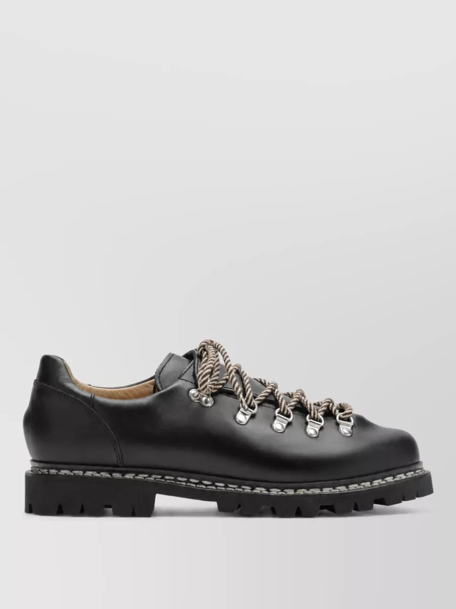 Paraboot Low-top sneakers — The Represent distressed brown sneakers echo the washed brown of the pants while the chunky off‑white sole mirrors the puddling hem and keeps the overall vibe street-first rather than hiking or outdoorsy.