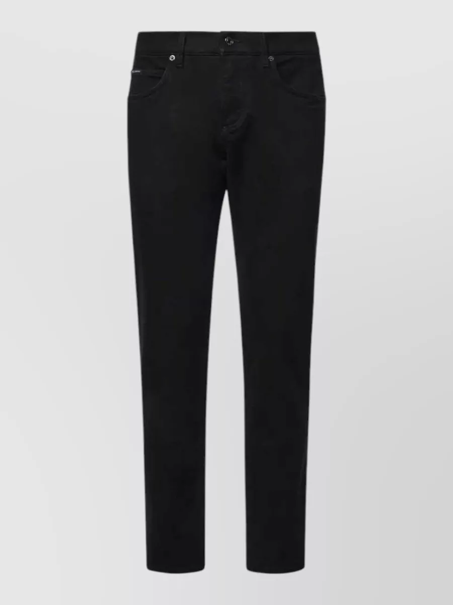 Dolce&Gabbana Denim jeans — The slim straight black Dolce&Gabbana denim keeps a clean line under the regular Dior tee, matching its minimalist quiet-luxury mood while staying versatile for day-to-night wear.