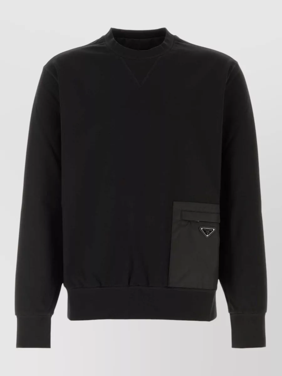 Prada Stretch jersey sweatshirt — The black Prada sweatshirt with technical pocket mirrors the jogger’s athletic minimalism and nylon detailing, creating a cohesive, elevated track-inspired set in the same luxury tier and palette.