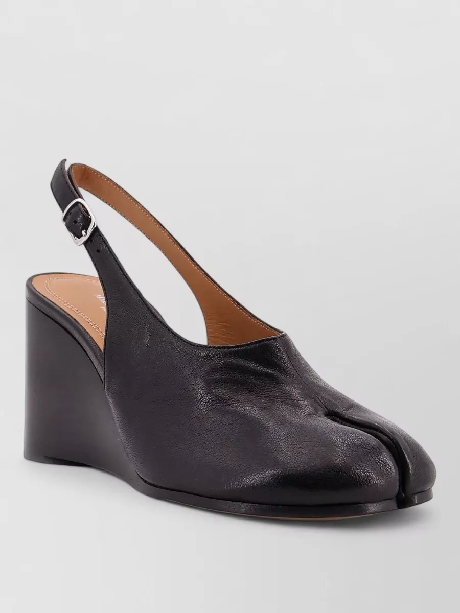 Maison Margiela Leather tabi pumps — The low-heel Tabi slingback gives a subtle lift and Margiela signature while keeping the profile light and refined against the volume of the wide-leg pant.
