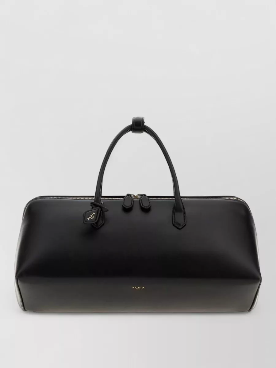 Alaïa leather medium delta travel bag