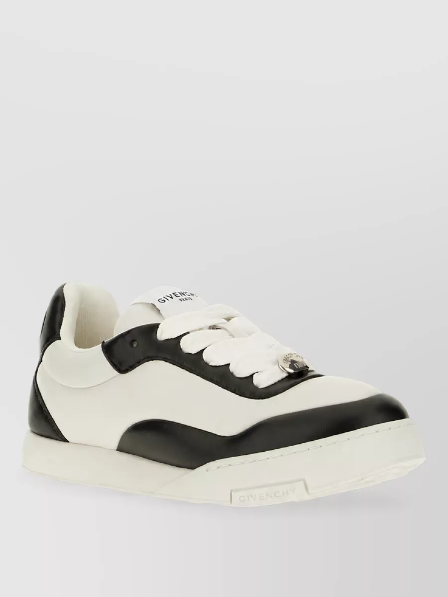 Givenchy Leather low-top sneakers — The creamy low-top sneaker keeps things in the casual-formal sweet spot and echoes the off-white trouser and tee for a cohesive, pared-back streetwear feel.