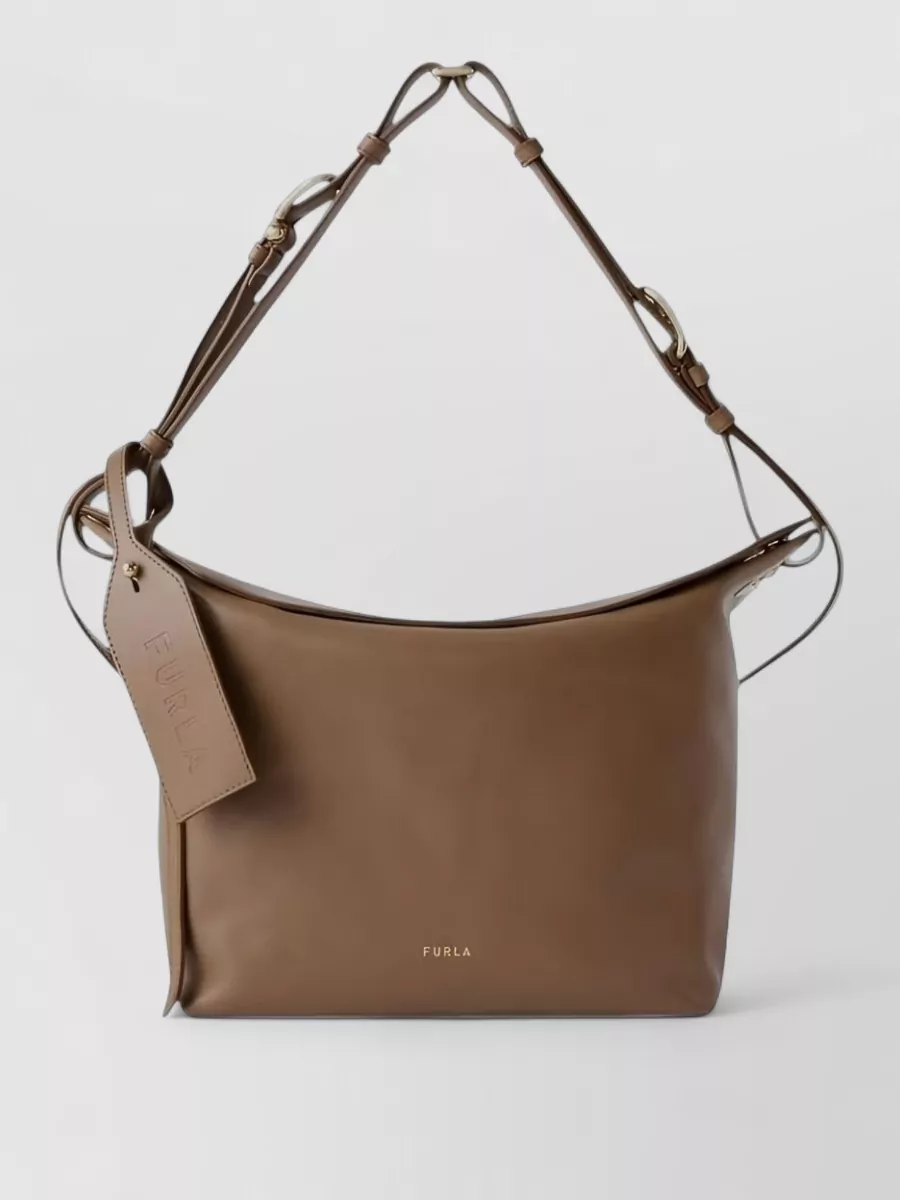 Furla Medium leather shoulder bag — The Furla taupe shoulder bag sits in the same neutral family as the knit and boots, adding a discreet, structured note that complements the quiet-luxury mood.