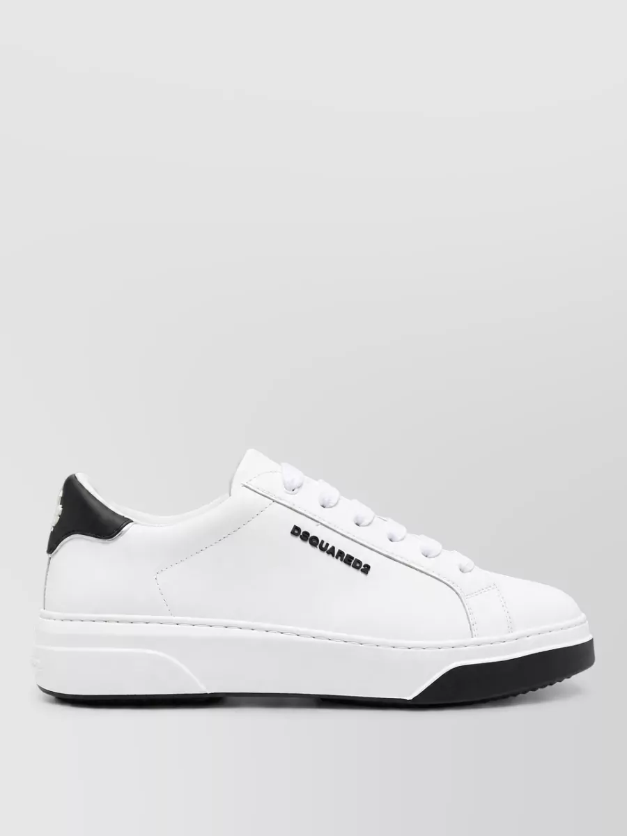 Dsquared2 Leather lace-up sneakers — The off white and sky blue sneakers echo the tee’s soft tones and yellow graphic, giving a subtle retro hit that keeps the set cohesive without overpowering the slogan.