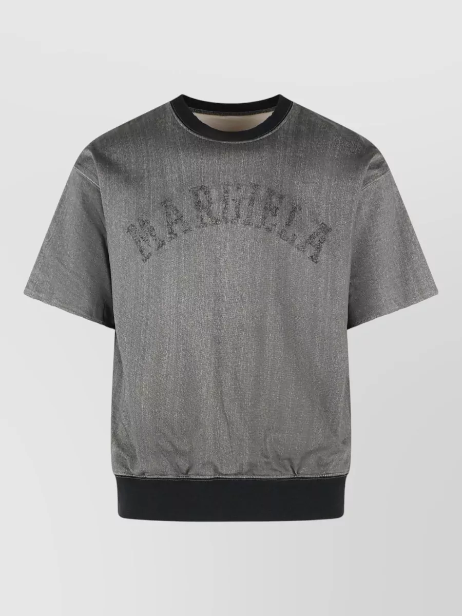 Maison Margiela Short-sleeve crewneck t-shirt — The oversized black Margiela tee mirrors the washed-black trouser in palette and attitude, keeping the silhouette wide and relaxed while staying firmly in the same street-luxe universe.