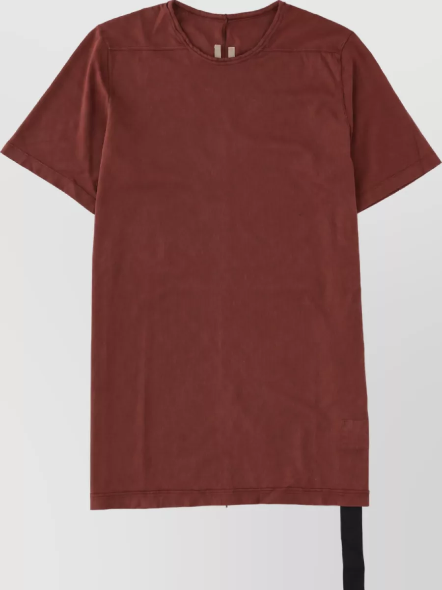 Rick Owens Drkshdw Shirt — The russet longline Rick tee mirrors the cocoa outerwear tone and elongated Rick proportions, giving a tonal column under the crewneck that keeps the palette rich and cohesive.