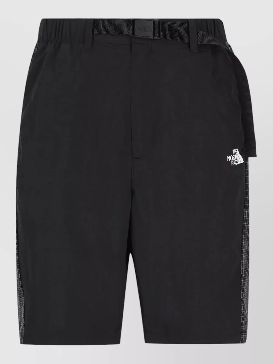 The North Face Track pants — H keeps the same black, technical, logo-lite energy as the tee, with a secure belted waist and clean mid-rise short that suits warm-weather street and trail days.