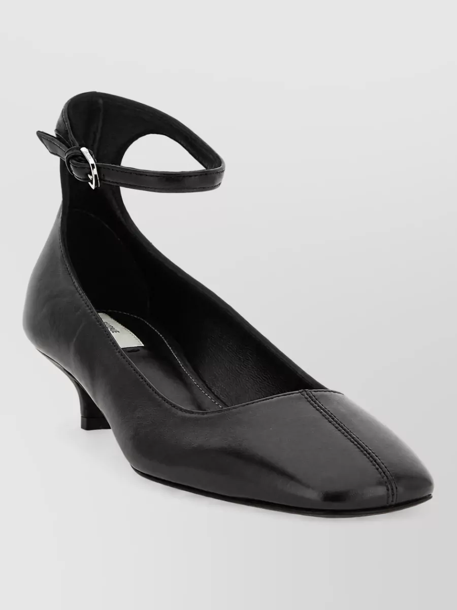 Totême Leather square-toe ballerina pumps — The black pointed kitten-heel pump has the right formality and precision to sharpen the soft ivory tailoring while remaining walkable and understated.