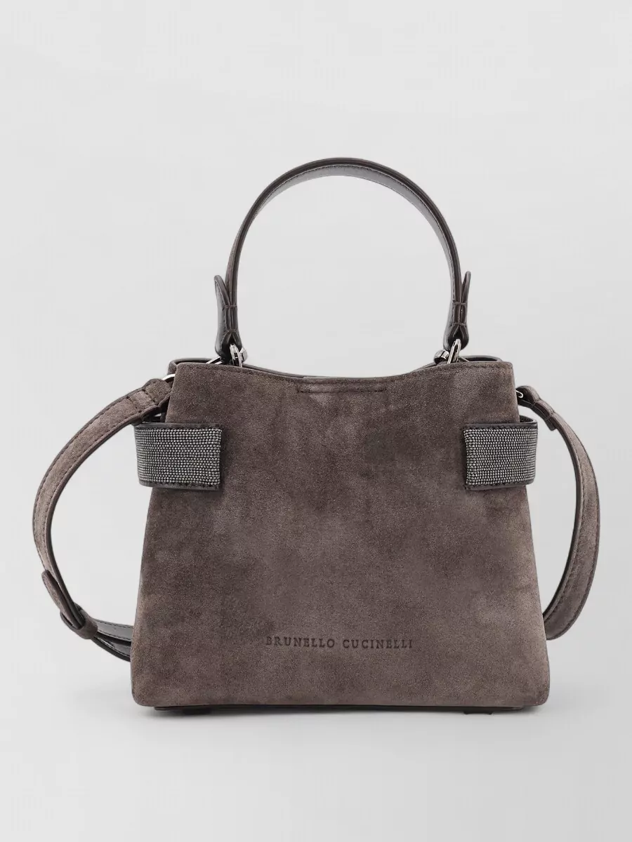 Brunello Cucinelli monili small leather tote bag — The structured taupe suede tote with subtle shimmer trim ties into the knit’s texture and the taupe shoes, adding a composed, day-ready finish that still feels softly luxurious.