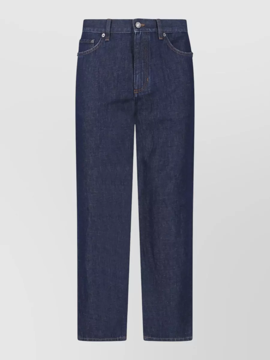 Zegna Denim mid-rise straight-leg jeans — The dark olive pleated trousers add tailored structure and a richer tonal contrast to the sand polo while staying within the same quiet luxury, warm-weather register.