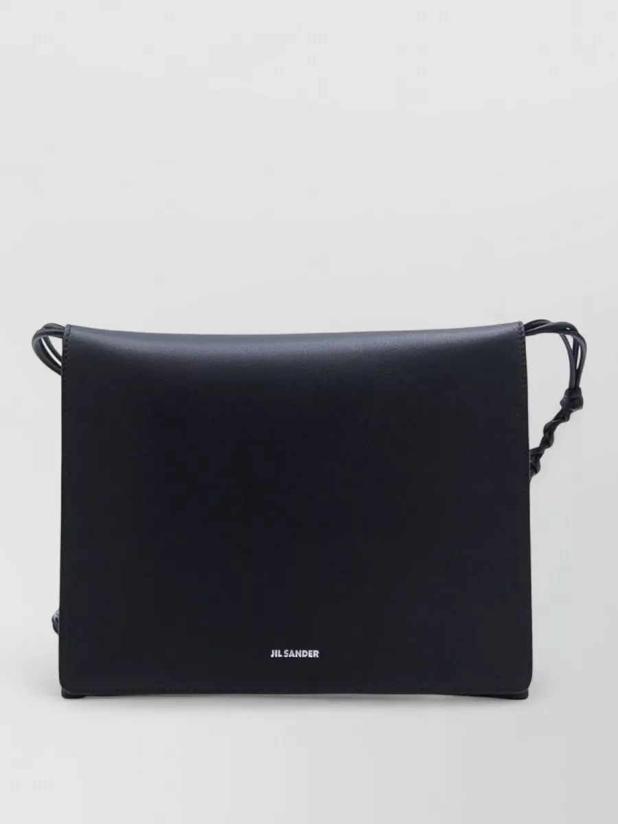Jil Sander Calf leather shoulder bag — The deep-navy Jil Sander crossbody sits quietly within the blue palette, matches the trouser’s formality, and keeps the silhouette sleek and unobtrusive.