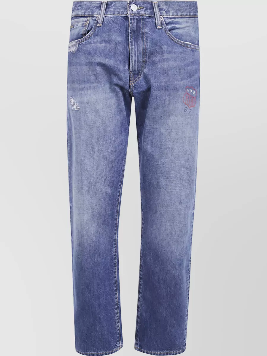 Polo Ralph Lauren Straight-leg jeans — The mid‑wash straight Polo denim with collegiate patch matches the tee’s preppy sports crest and relaxed fit, creating an easy campus‑ready uniform that feels seasonally right for cooler months.