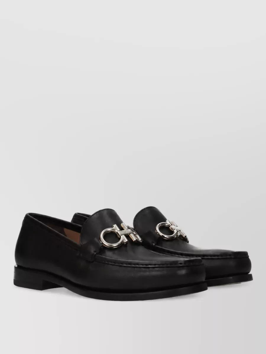 Ferragamo Leather loafers — The clean black penny loafers match the trouser’s formality and quiet-luxury tone, and their sleek profile balances the volume of the wide leg without feeling heavy.