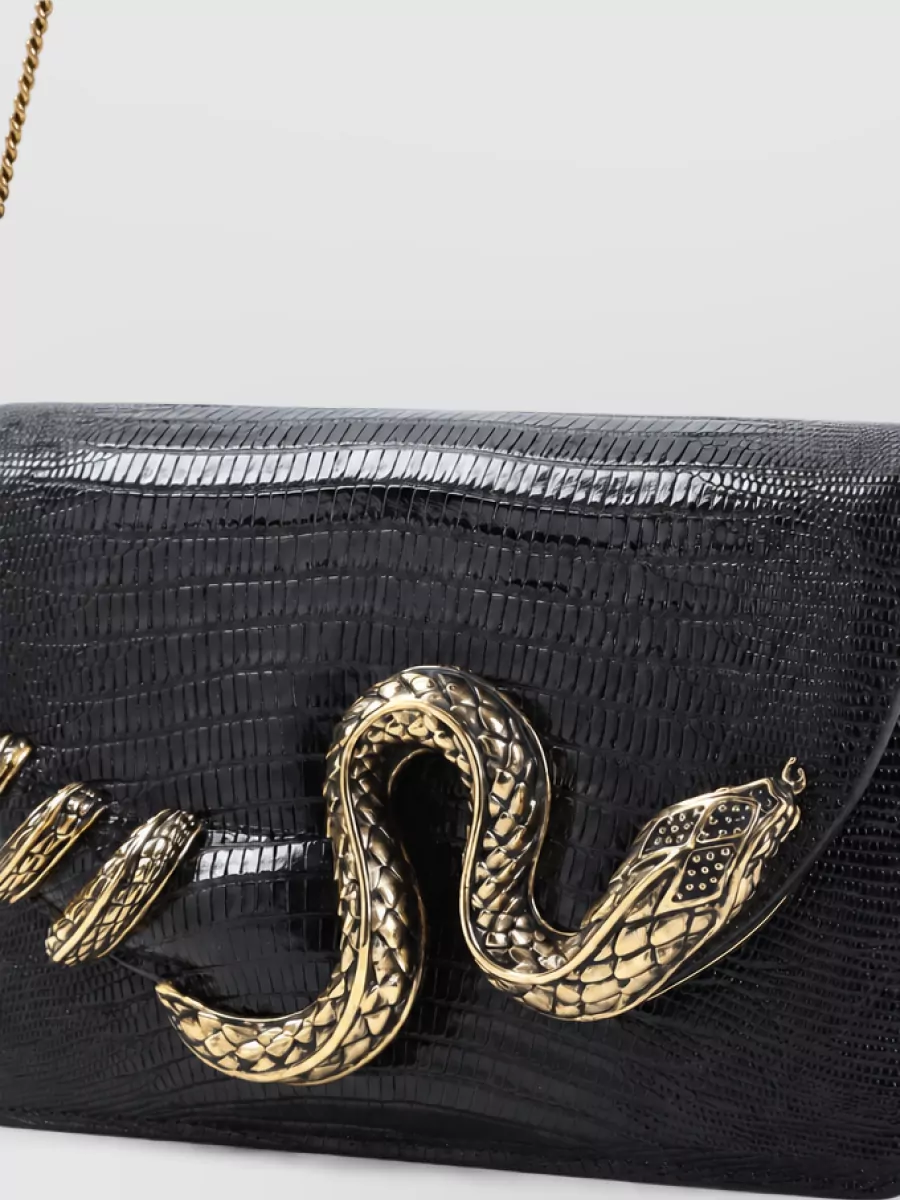 Roberto Cavalli Leather shoulder bag — The Roberto Cavalli black croc clutch with gold snake hardware ties into the dress brand-wise, grounds all the leopard in sleek black, and reinforces the nocturnal, high-glam y2k energy.