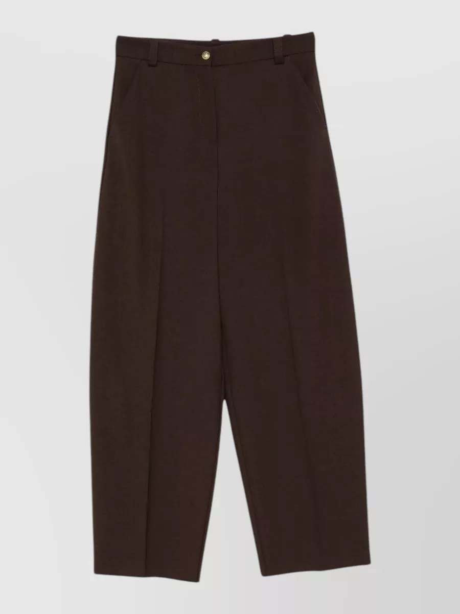 Pinko Wide-leg trousers — The dark chocolate high-waisted wide-leg trouser creates a tonal column with the jacket, balancing its volume and giving a modern, architectural streetwear silhouette in the same color family.
