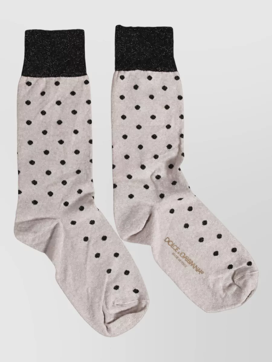 Dolce&Gabbana Dotted stretch socks — The sheer glitter polka-dot socks add a subtle romantic twist between trouser hem and combat boot, echoing the top’s sparkle in a playful yet not overwhelming detail.