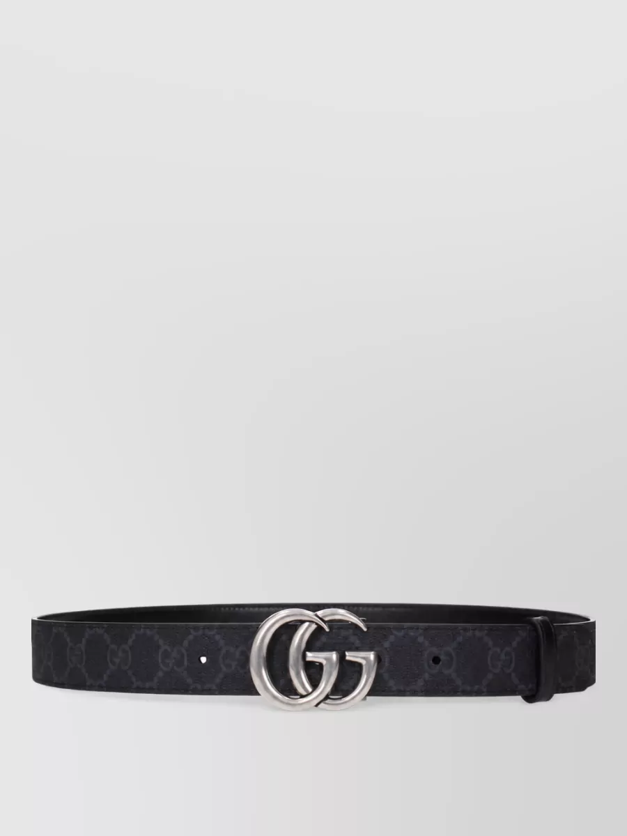 Gucci Fabric belt — The black Double G belt in dark monogram leather adds a discreet waist definition and a small note of branding that aligns with the outfit’s refined, formal mood.