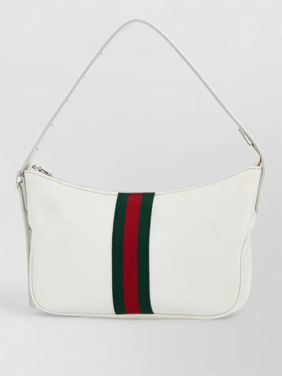 Gucci Leather small shoulder bag — The Casablanca navy and green crochet tote mirrors the texture play of the shorts and top while its darker body grounds the light outfit in a relaxed, Riviera-ready way.