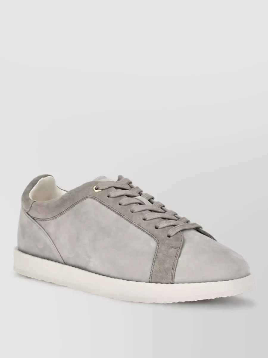 Brunello Cucinelli Suede leather low top sneakers — Brunello Cucinelli’s dove-grey suede sneaker in I keeps the mood refined yet relaxed, tonally linking to the sweater and trouser while maintaining a clean, streamlined profile.
