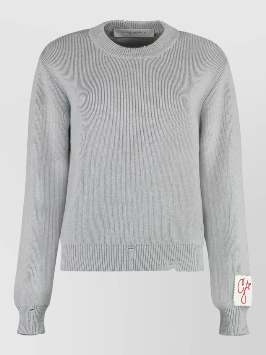 Golden Goose Ribbed cotton crew-neck sweatshirt — The light grey cropped knit with subtle distressing mirrors the sneakers’ off-white and grey tones and keeps the vibe relaxed streetwear while balancing the wide leg visually.