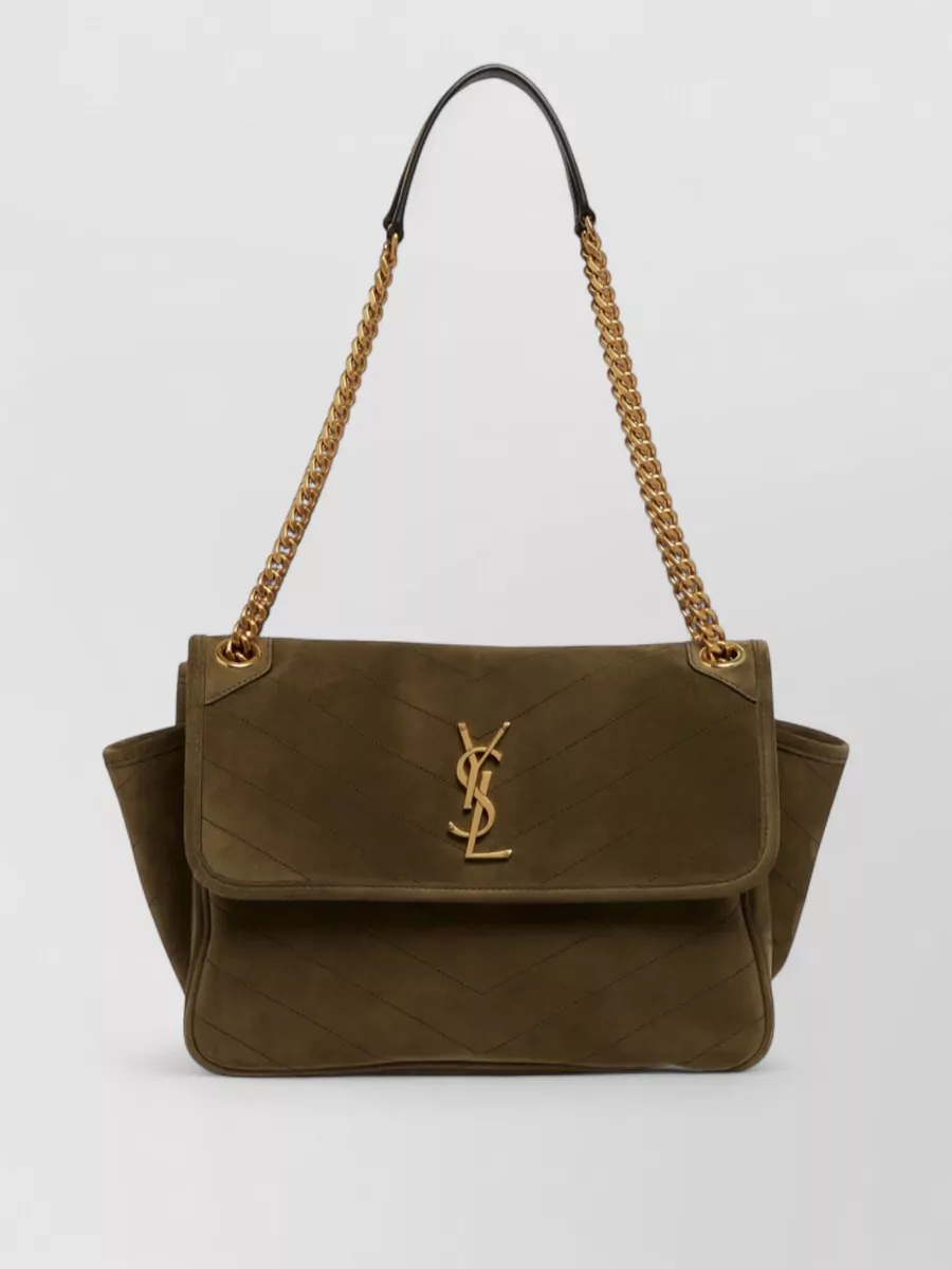 Saint Laurent niki suede shoulder bag — The Saint Laurent olive suede shoulder bag harmonises with the coat’s deep olive palette and gold buttons, reinforcing the quiet-luxury mood with structured but soft sophistication.