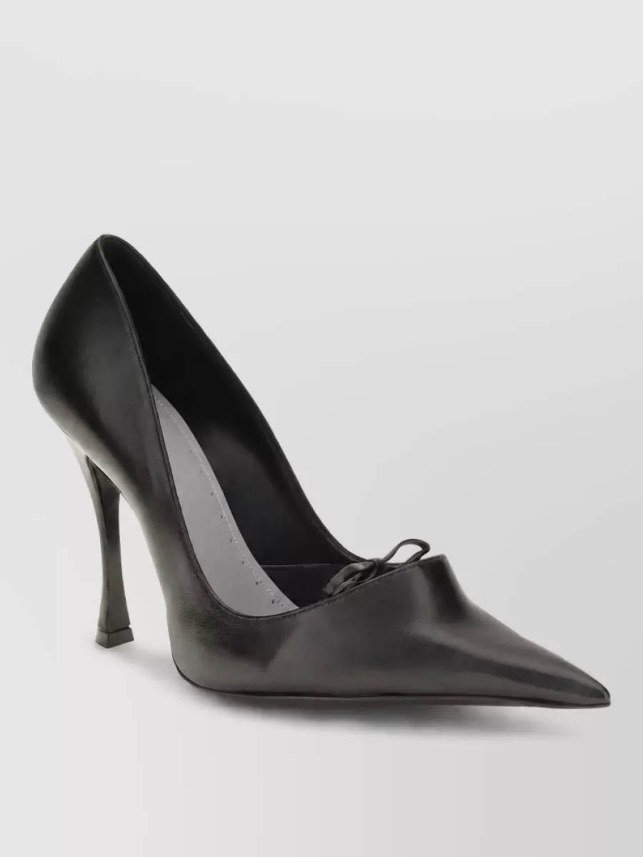Balenciaga Leather bloom pumps — The chunky, polished black derby in C grounds the fluid volumes with a tailored, gender-neutral edge that fits the quiet-luxury streetwear brief and works in cooler seasons.