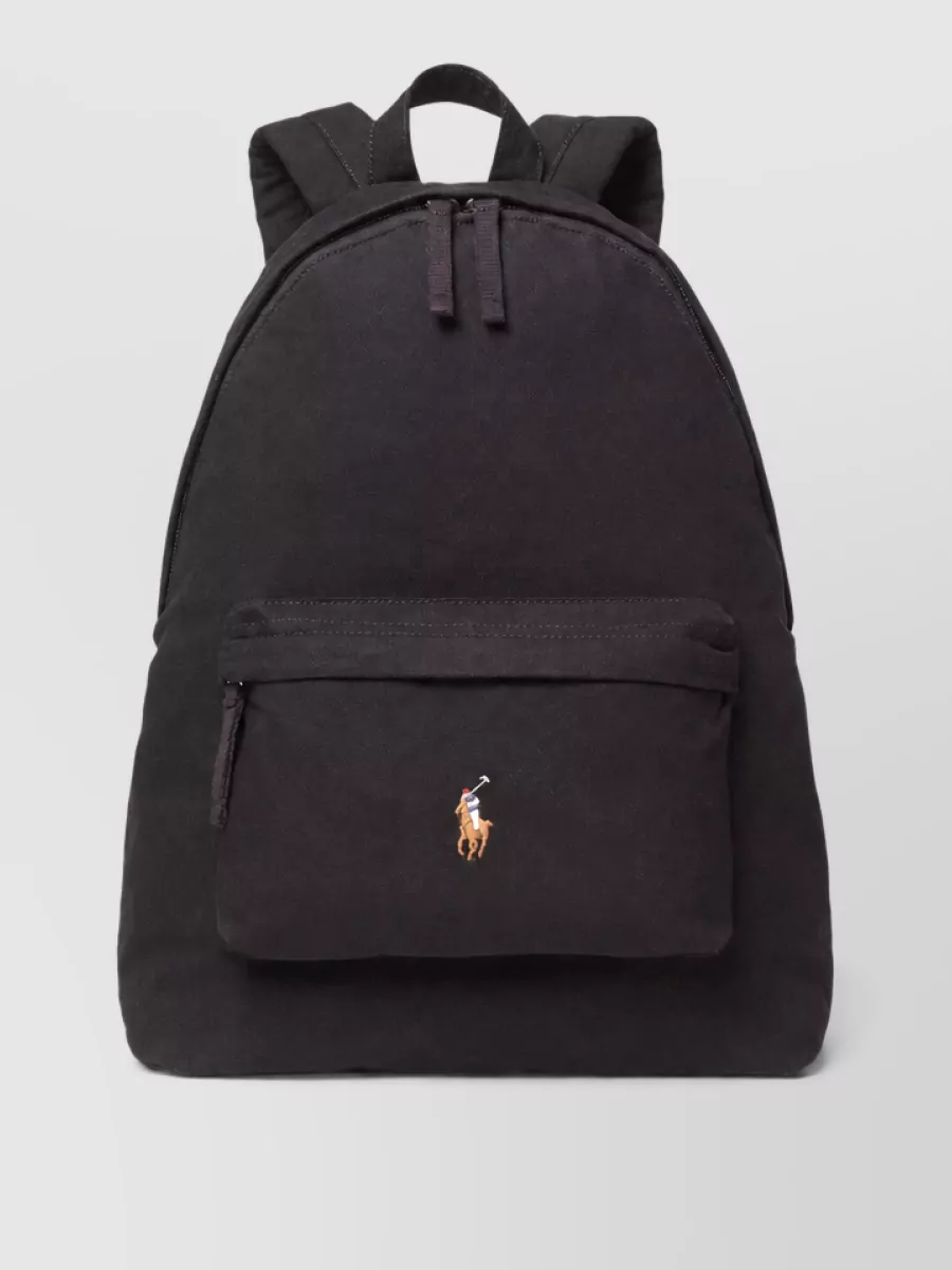 Ralph Lauren Canvas backpack — The black Ralph Lauren backpack reinforces the collegiate, sport-preppy attitude and matches the black base while offering practical structure for everyday wear.