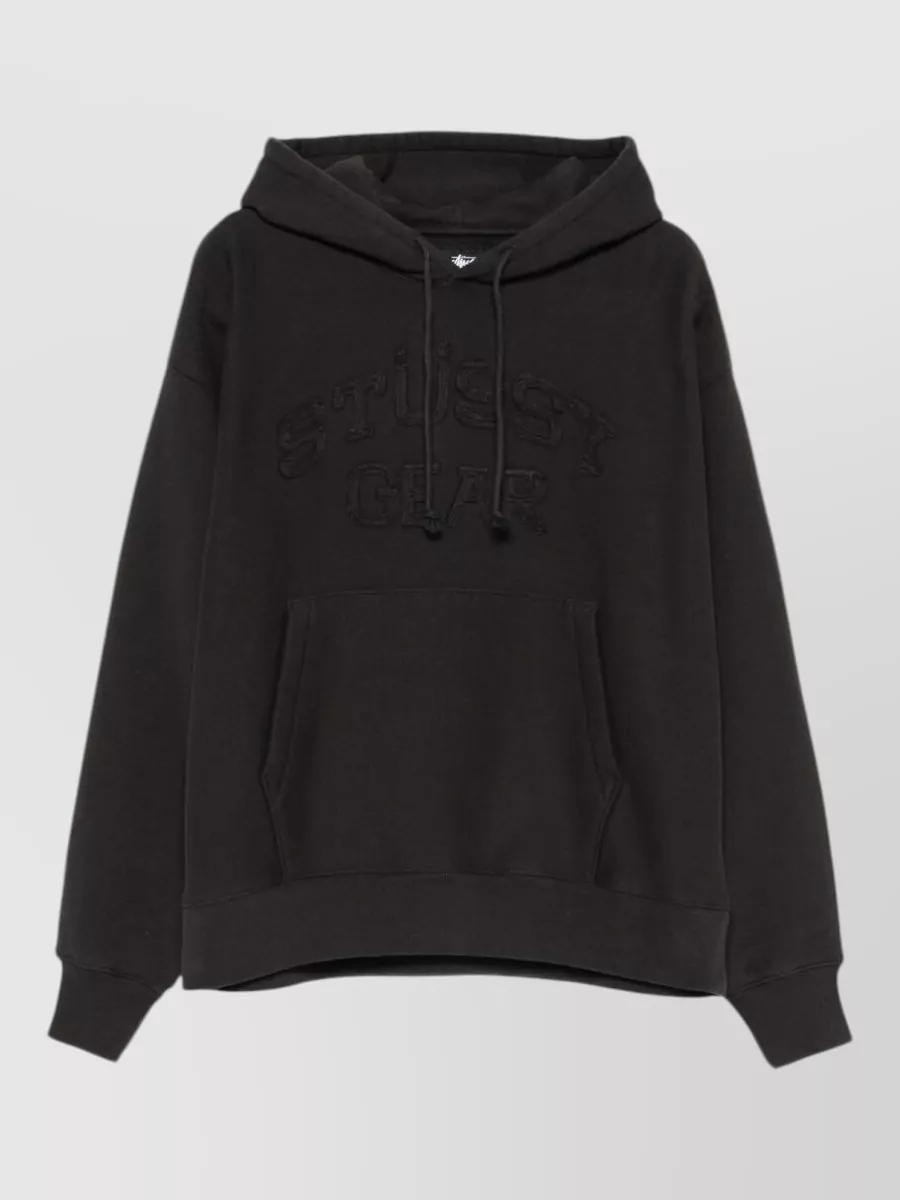 Stüssy Logo-print hoodie — The washed black Stüssy hoodie leans into the shorts’ streetwear and utility attitude, keeps the palette tight in charcoal tones, and balances the regular-fit mid-length short with a relaxed, slightly oversized top block.