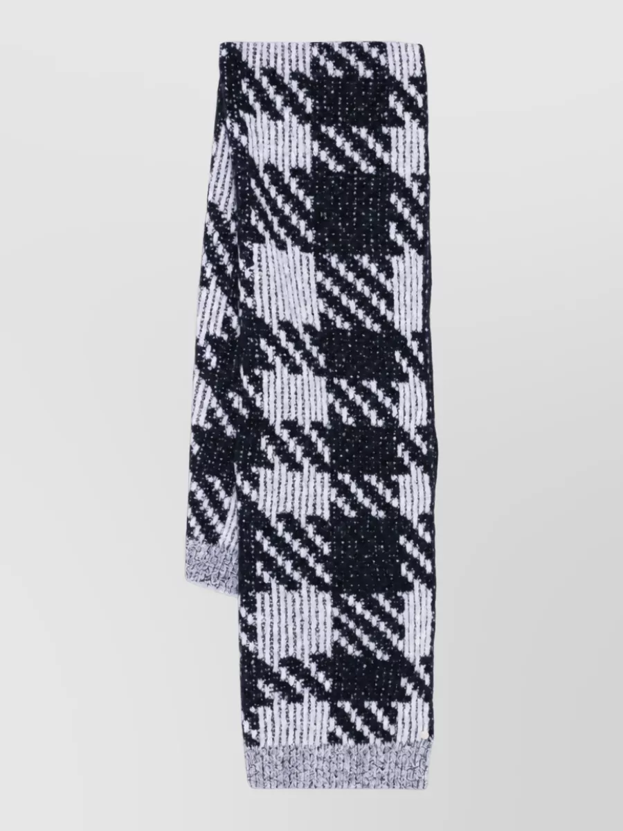 Dries Van Noten Wool alpaca scarf — The Dries Van Noten black-and-white abstract check scarf riffs on the sweater’s disrupted grid in a different scale and texture, reinforcing the monochrome story without introducing new color.