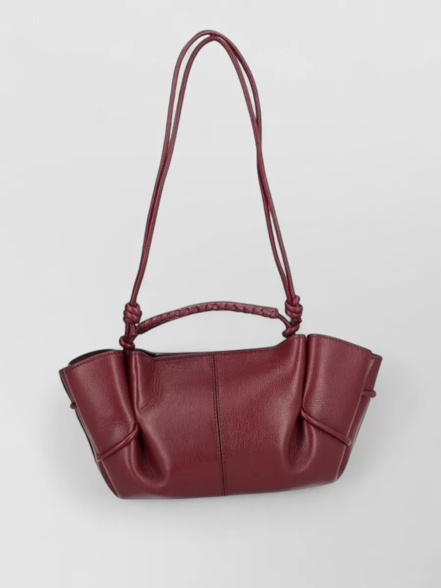 Hereu Leather shoulder bag — Hereu’s deep burgundy shoulder bag keeps the palette tonal with subtle texture contrast, sitting at the same understated formality as the knit, skirt and loafers.