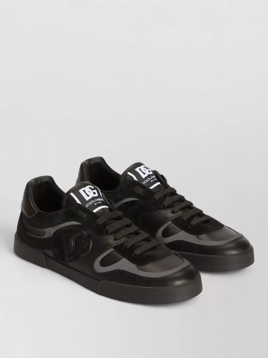 Dolce&Gabbana Leather lace-up sneakers — The Dolce&Gabbana combat boots bring a premium, lugged counterweight to the straight denim and grungey crew, staying in a dark palette that sharpens the streetwear without feeling flashy.