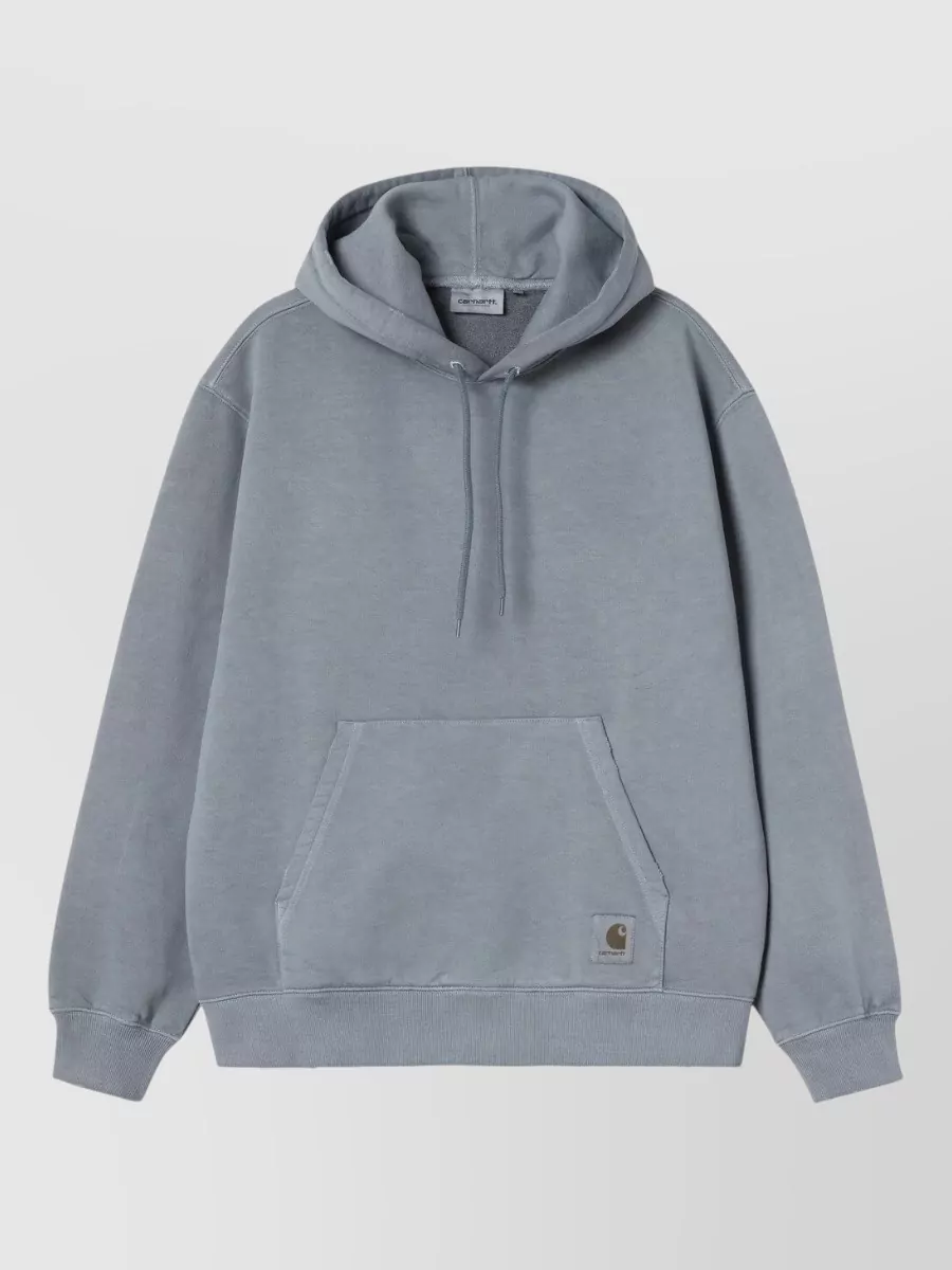 Carhartt Wip Hoodie — The washed steel blue hoodie relaxes the double-denim story, echoing the jacket’s fade while softening it with street-led volume and a casual hood under the chore collar.