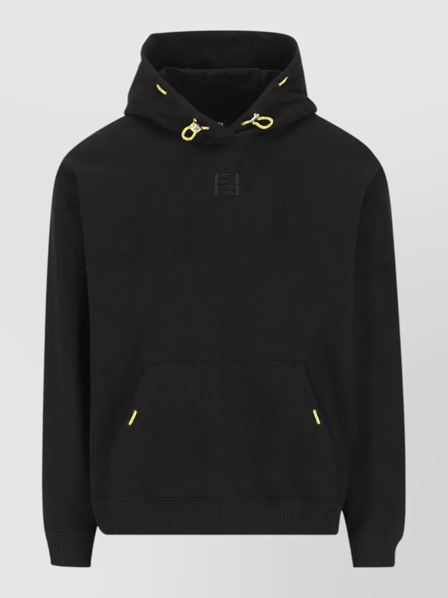 Fendi Cotton logo-embroidered hoodie — The black Fendi hoodie with neon cords mirrors the gilet’s sporty streetwear mood and keeps a dark, streamlined column under the vest, letting the texture and tactical details read clearly while the neon drawcords echo the hardware energy.