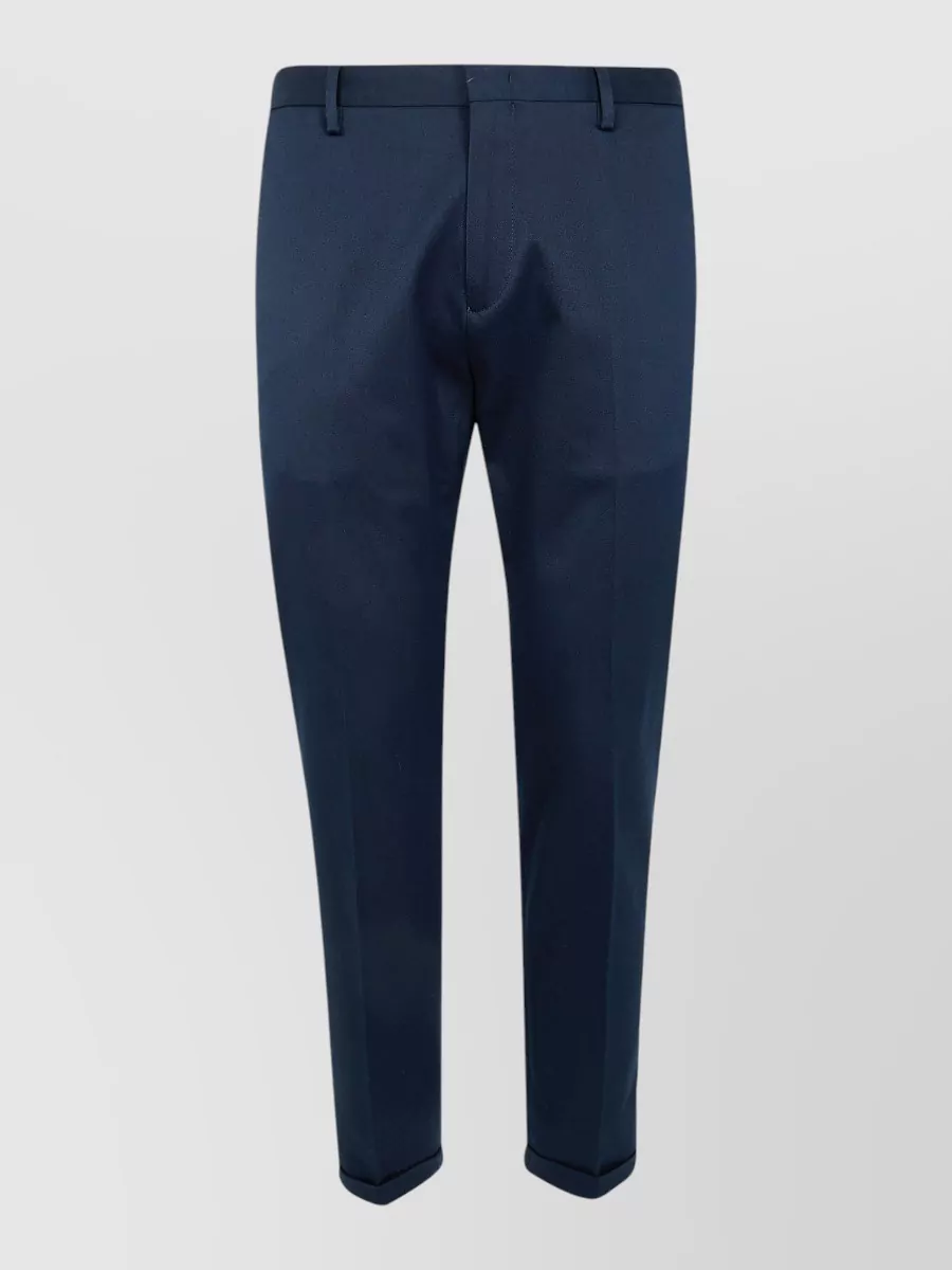 Paul Smith Tailored trousers — The slim ink navy trouser mirrors the sweater’s refined minimalist mood and palette, giving a clean, tailored line that keeps the outfit quietly formal without introducing extra colour or pattern.