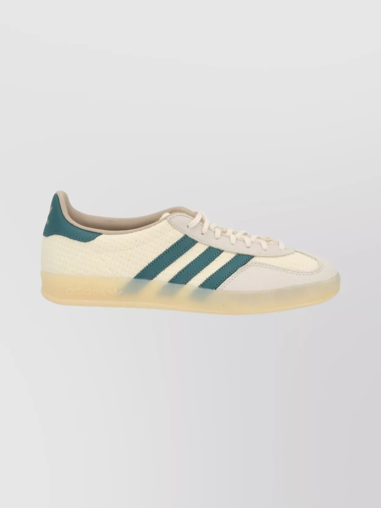 Adidas Originals Leather low-top sneakers — The cream-and-teal terrace sneakers quietly pick up the tee’s blue-green notes, stay slim so legs look long with the mini, and sit in the same elevated sport tier as Casablanca.