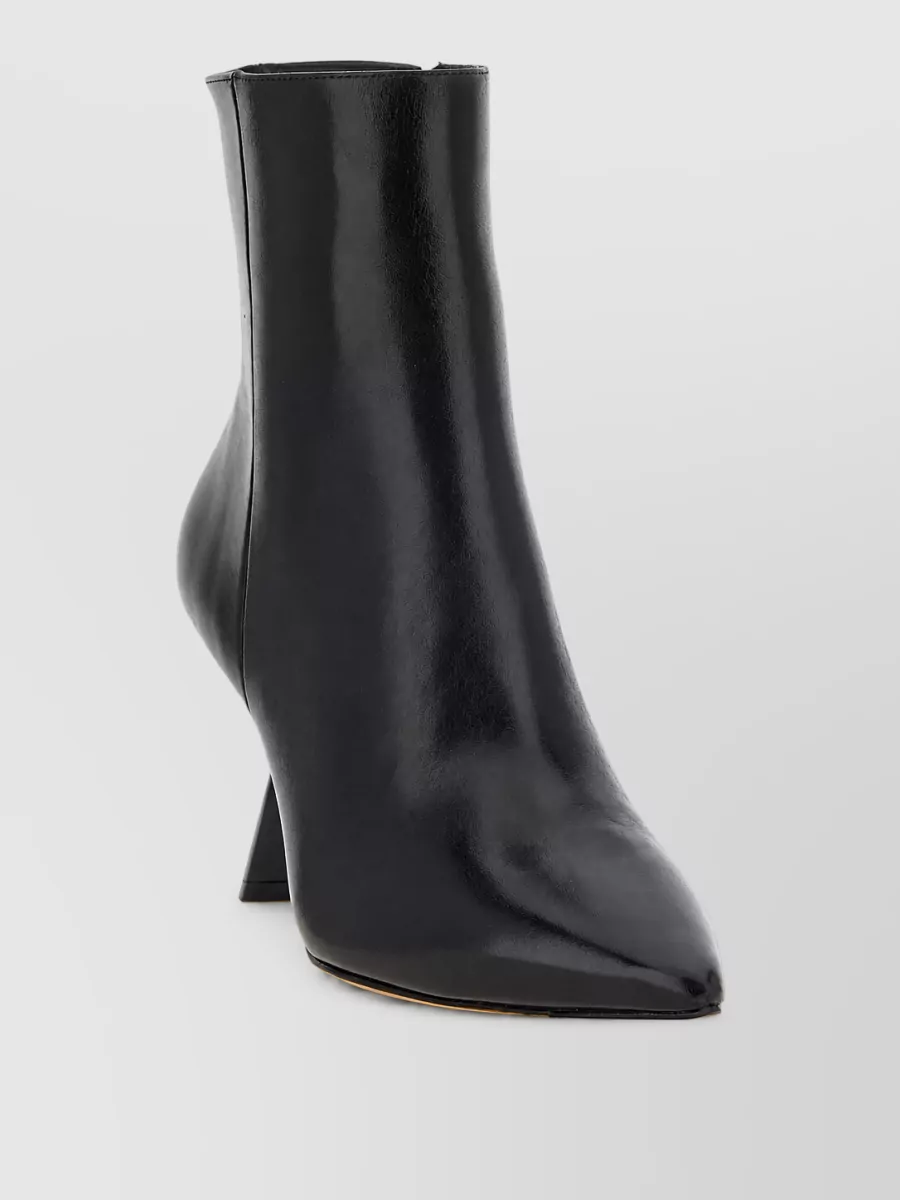 Alexandre Birman Leather ankle boots — The Alexandre Birman black pointed ankle boots sharpen the flare of the jeans and reinforce the tailored, slightly retro Y2K attitude while staying luxe and season-appropriate.