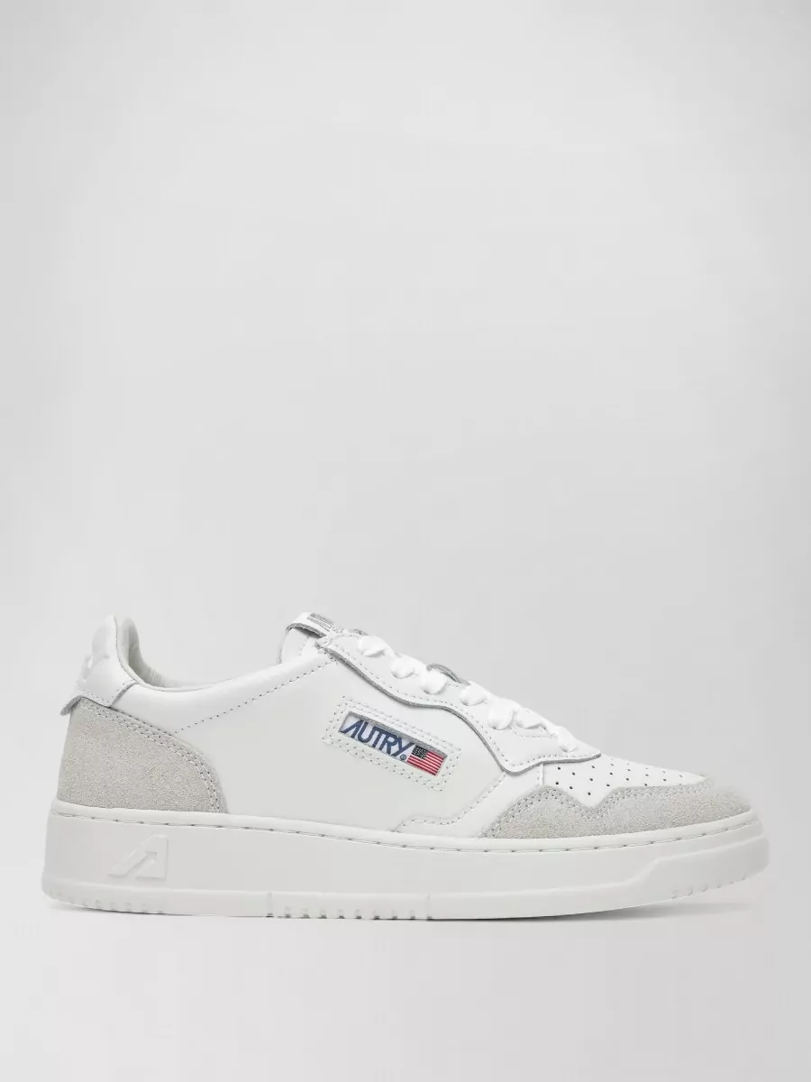 Autry Low-top sneakers — The white Autry with light grey suede and navy detail hits the clean court-sneaker note the tee calls for, echoing its sporty minimalism while keeping the outfit light and not overbranded.