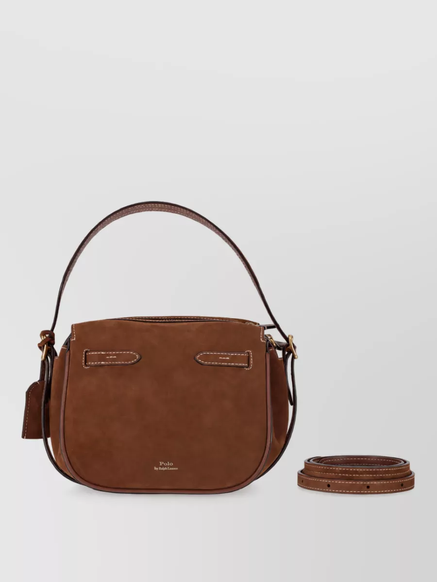 Ralph Lauren Leather shoulder bag — The tan and dark chocolate saddle bag perfectly matches the boot and skirt tones while leaning into the same polished Americana, equestrian-inspired aesthetic as the cardigan.