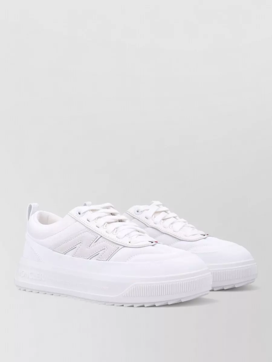 Moncler Altive low-top sneakers — The padded white Moncler sneaker keeps the silhouette light at the hem, extends the soft neutral story and reinforces the quiet sport character while staying comfortably polished.